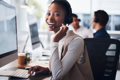 IT support professional wearing a headset at a computer