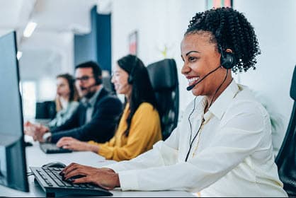 Support professionals working at computers in an office